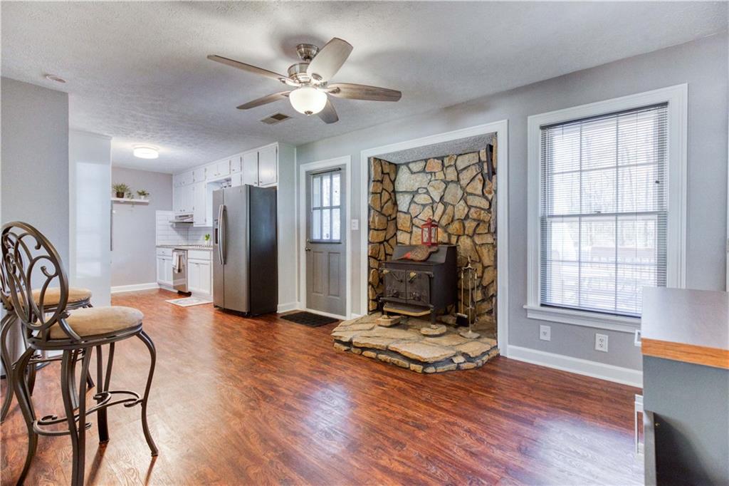 23 Woodland Road Auburn, GA 30011 - Photo 12 of 34 a view of a livingroom with furniture window and wooden floor