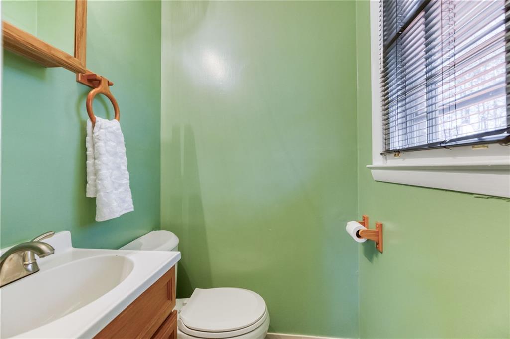 23 Woodland Road Auburn, GA 30011 - Photo 20 of 34 a bathroom with a sink a toilet and a mirror