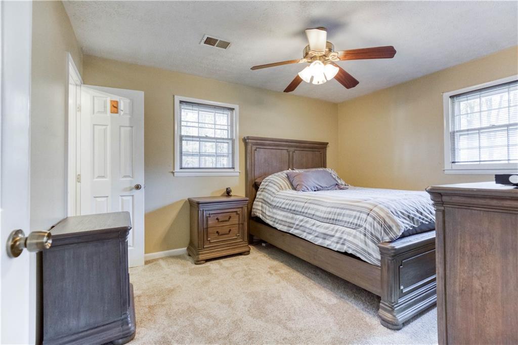 23 Woodland Road Auburn, GA 30011 - Photo 21 of 34 a bedroom with a bed and a chandelier