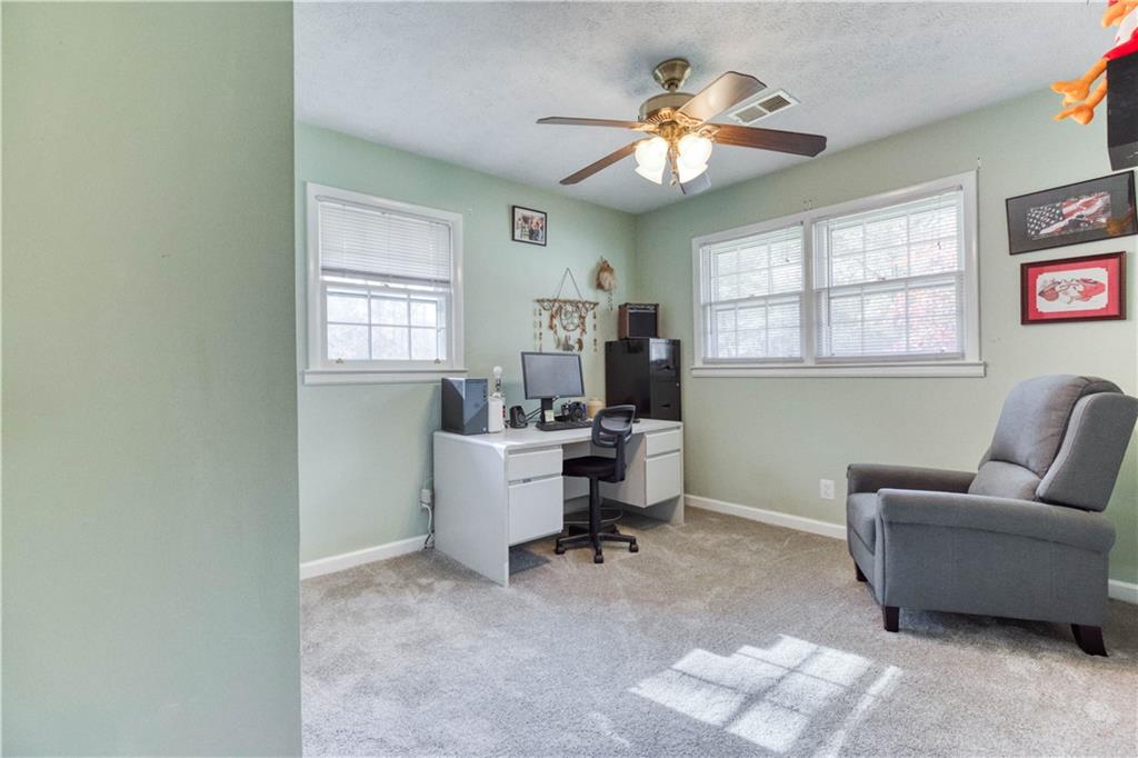 23 Woodland Road Auburn, GA 30011 - Photo 23 of 34 a view of a livingroom with workspace and a window