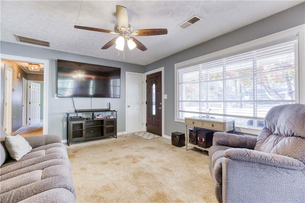 23 Woodland Road Auburn, GA 30011 - Photo 6 of 34 a living room with furniture and a flat screen tv