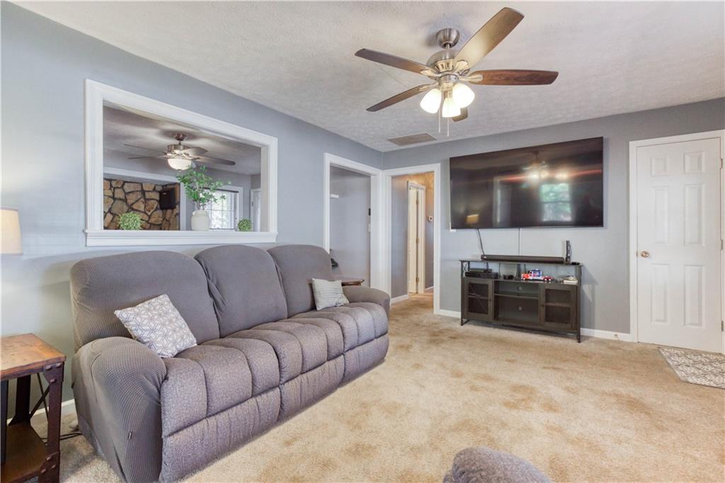 23 Woodland Road Auburn, GA 30011 - Photo 7 of 34 a living room with furniture and a flat screen tv