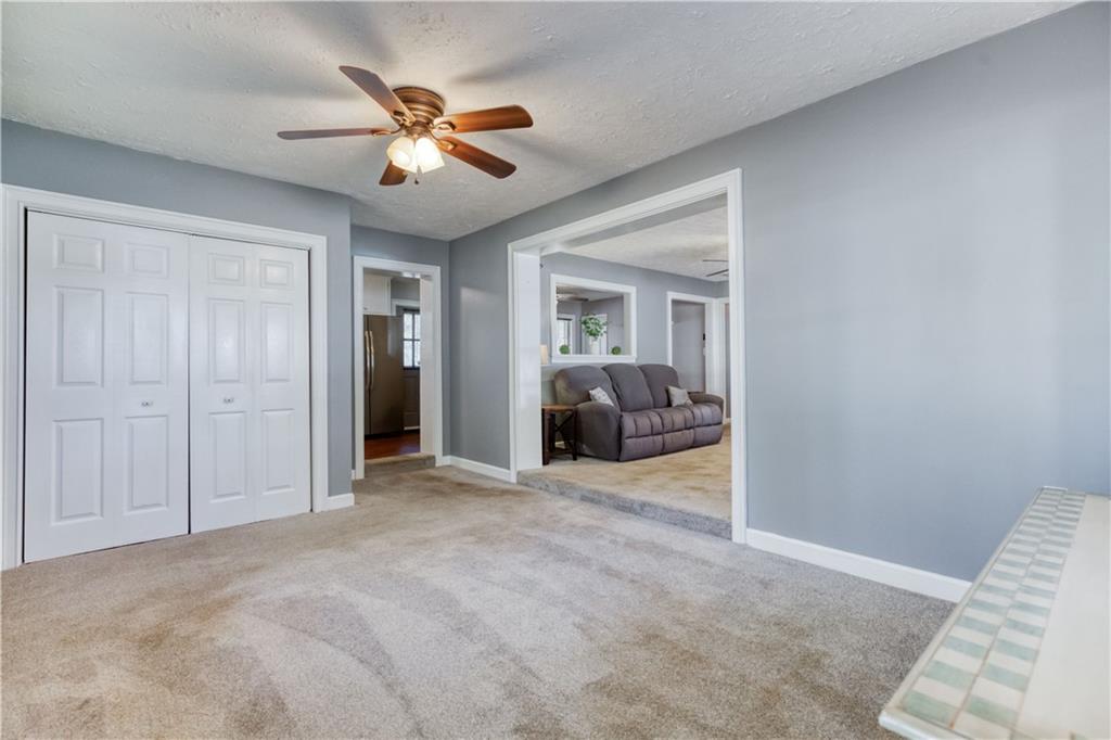 23 Woodland Road Auburn, GA 30011 - Photo 8 of 34 a view of a livingroom with a ceiling fan and wooden floor