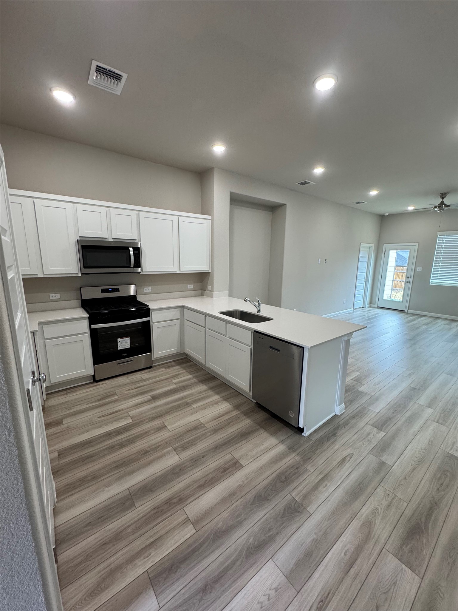 108 Bendecido Loop Elgin, TX 78621 - Photo 3 of 14 a large kitchen with stainless steel appliances a large counter top