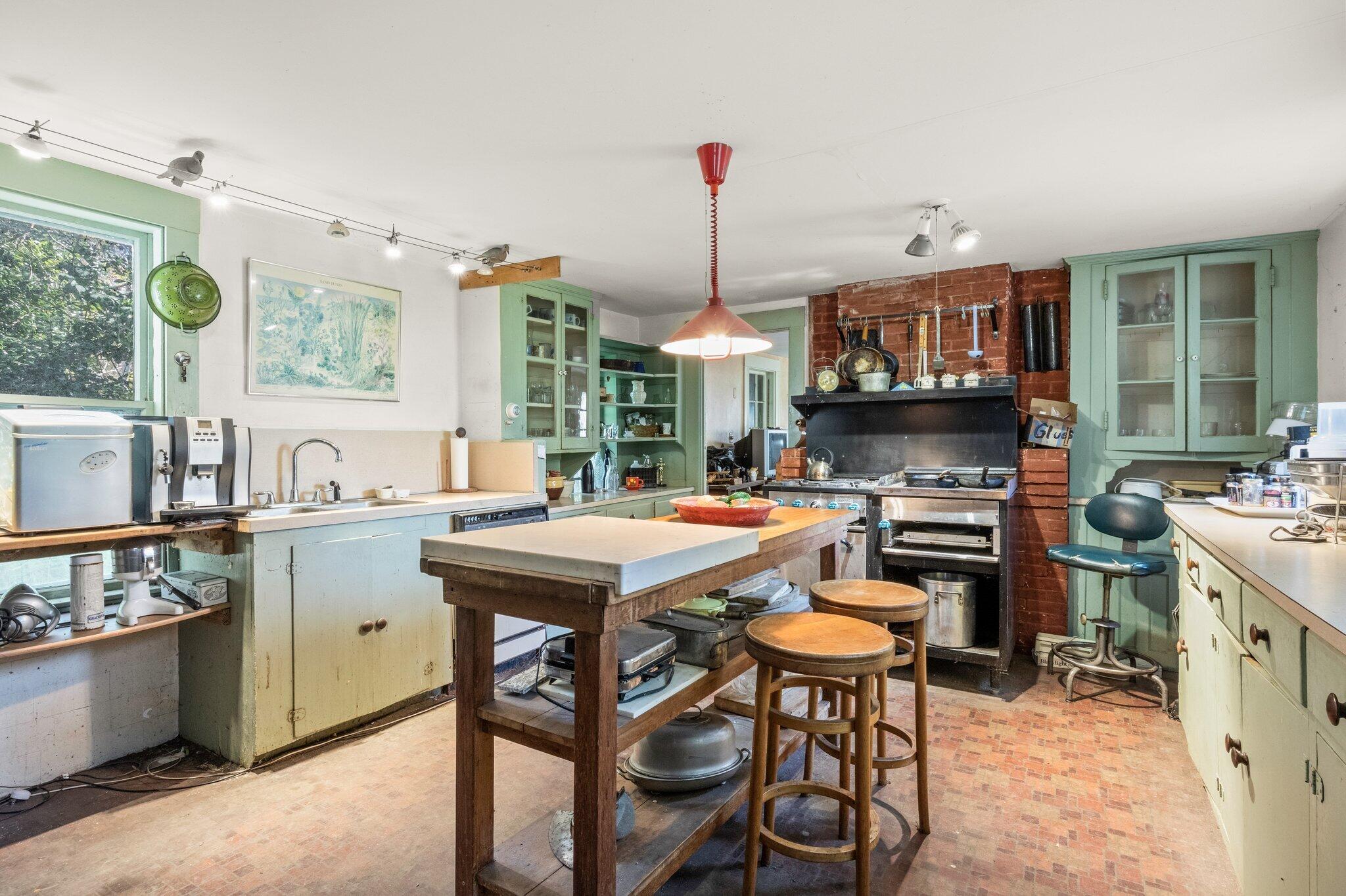 18 Sandpiper Road Truro, MA 02666 - Photo 1 of 19 a open kitchen with stainless steel appliances granite countertop a stove top oven a sink a counter and chairs