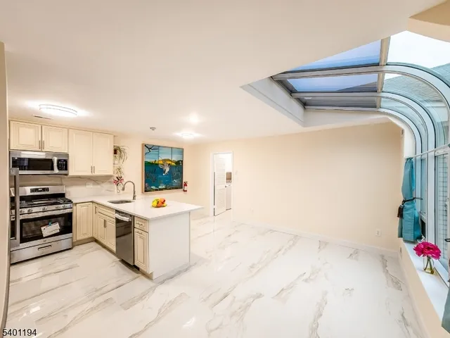 a kitchen with a stove and white cabinets
