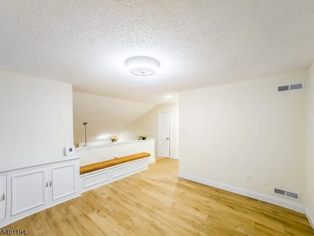 a view of a room with a wooden floor and a window