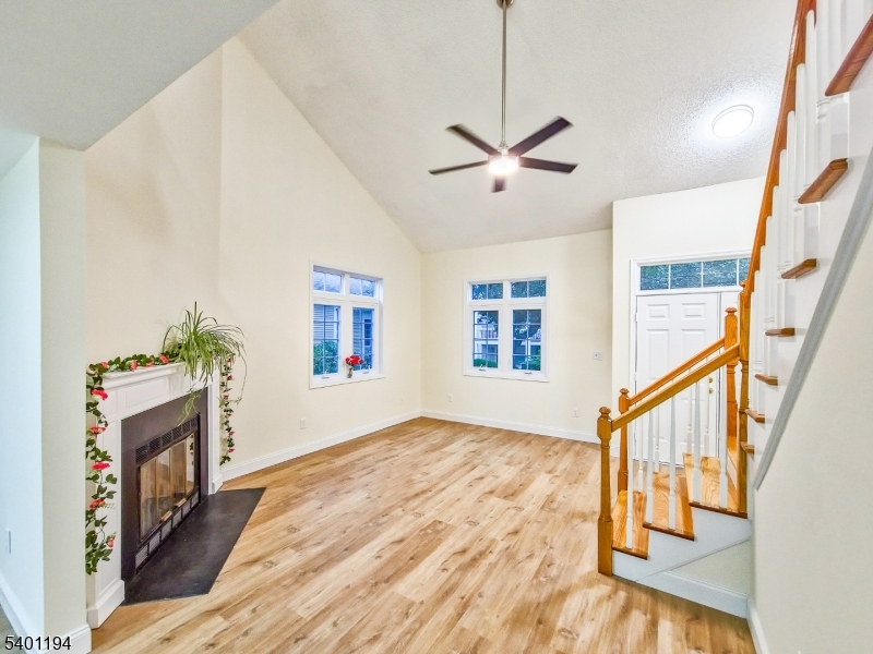7B Rutland Lane Monroe Township, NJ 08831 - Photo 8 of 36 a view of an empty room with window and wooden floor