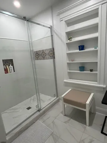a bathroom with a shower and a sink