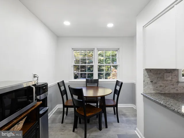a view of a dining room with furniture and a window