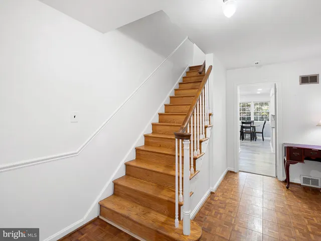 a view of entryway and hall with wooden floor