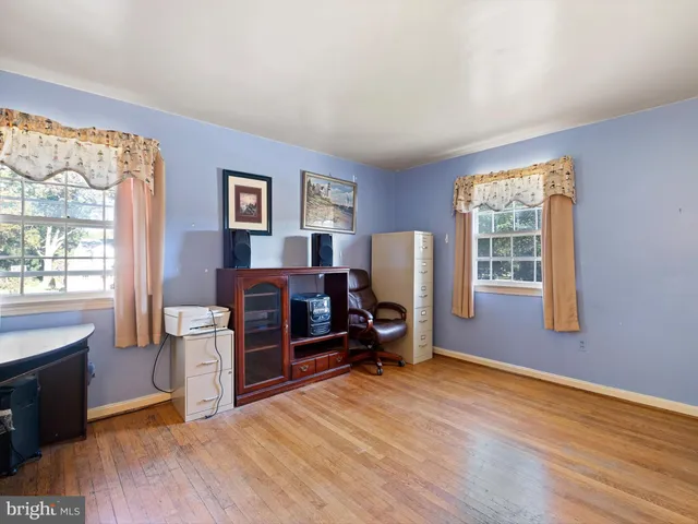 a room with furniture a flat screen tv and a window