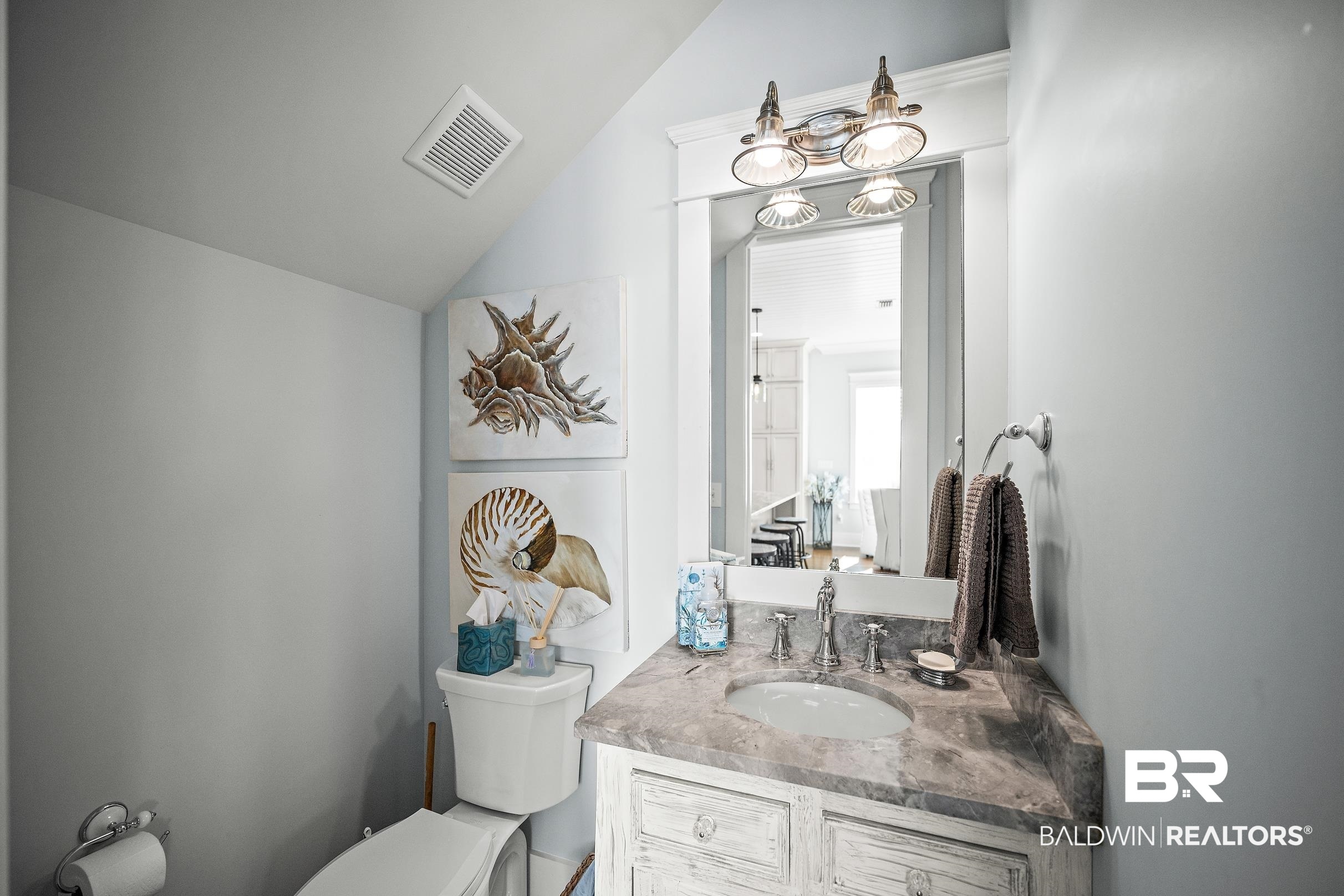 33186 Marlin Key Drive Orange Beach, AL 36561 - Photo 45 of 87 Half bath with vanity and vaulted ceiling