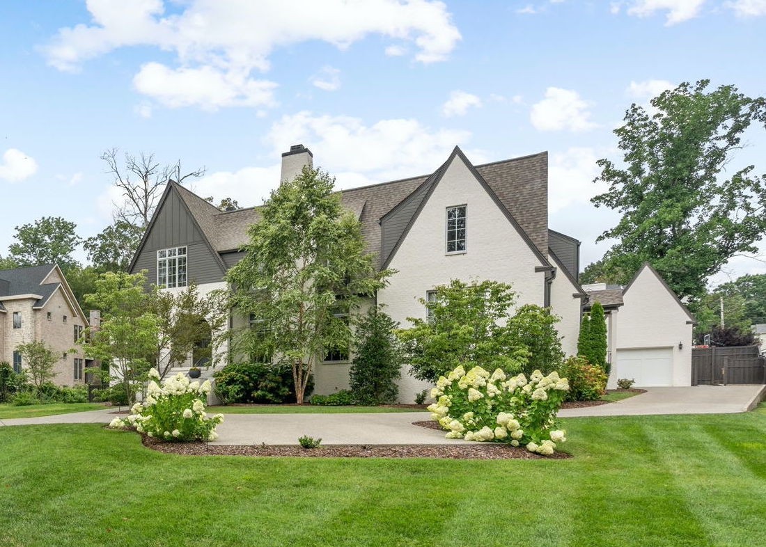 a view of a house with a yard and garden