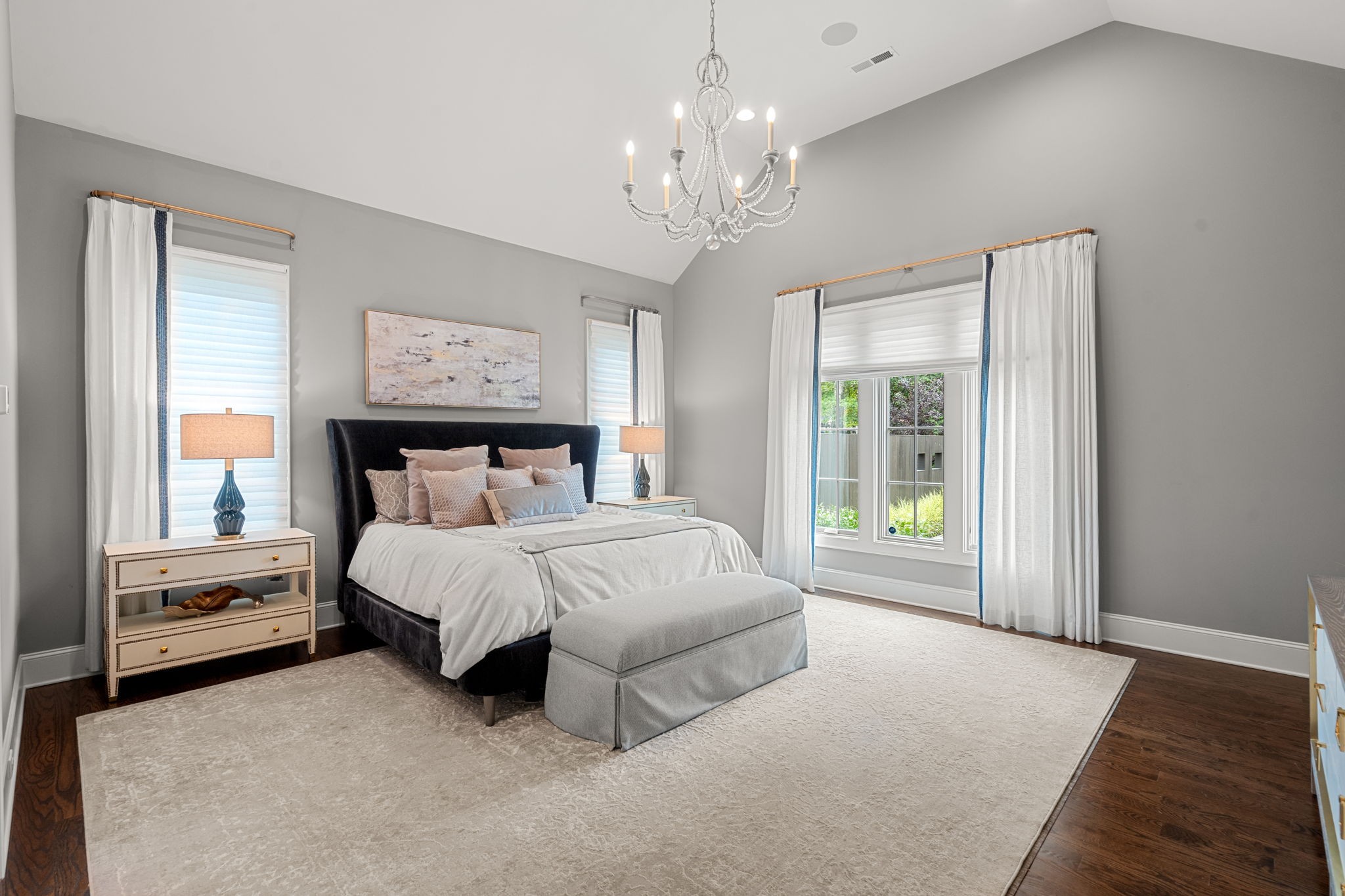 4031 Sneed Road Nashville, TN 37215 - Photo 25 of 61 a spacious bedroom with a large bed and a chandelier next to a window