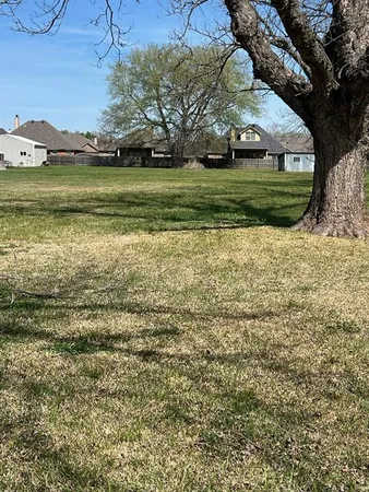 a view of a field with an ocean