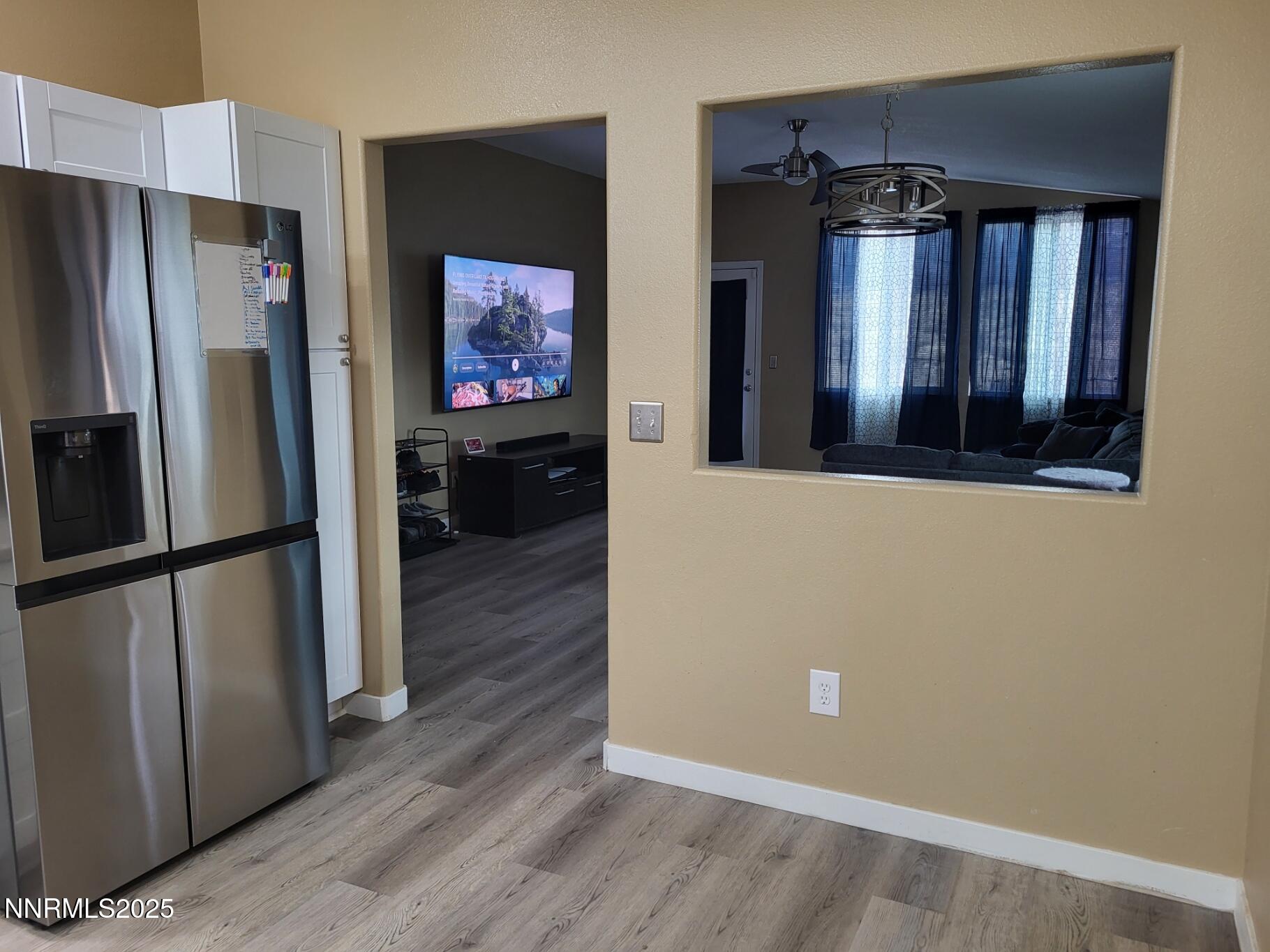 7871 Anchor Point Court Reno, NV 89506 - Photo 11 of 42 a view of a refrigerator in kitchen and wooden floor