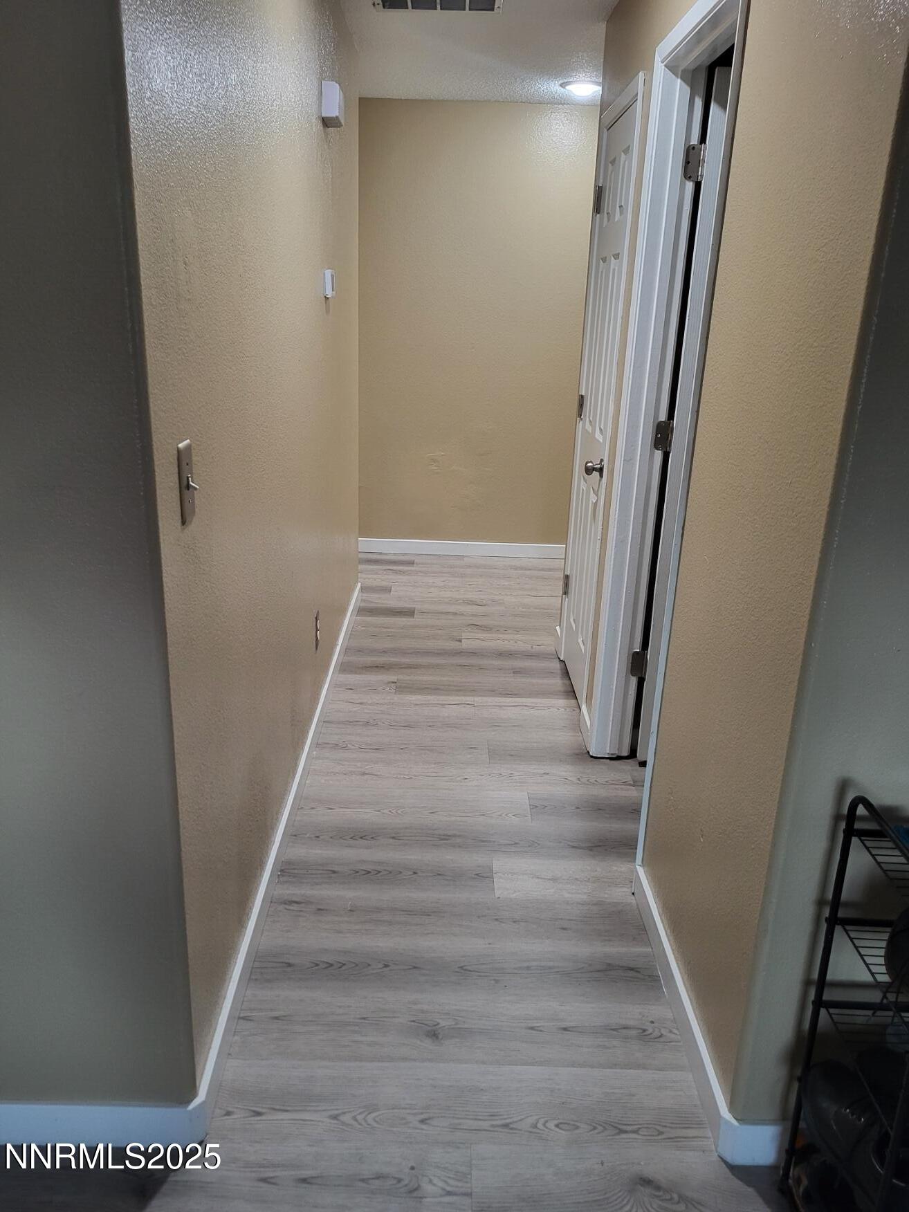 7871 Anchor Point Court Reno, NV 89506 - Photo 12 of 42 a view of a hallway with wooden floor and staircase