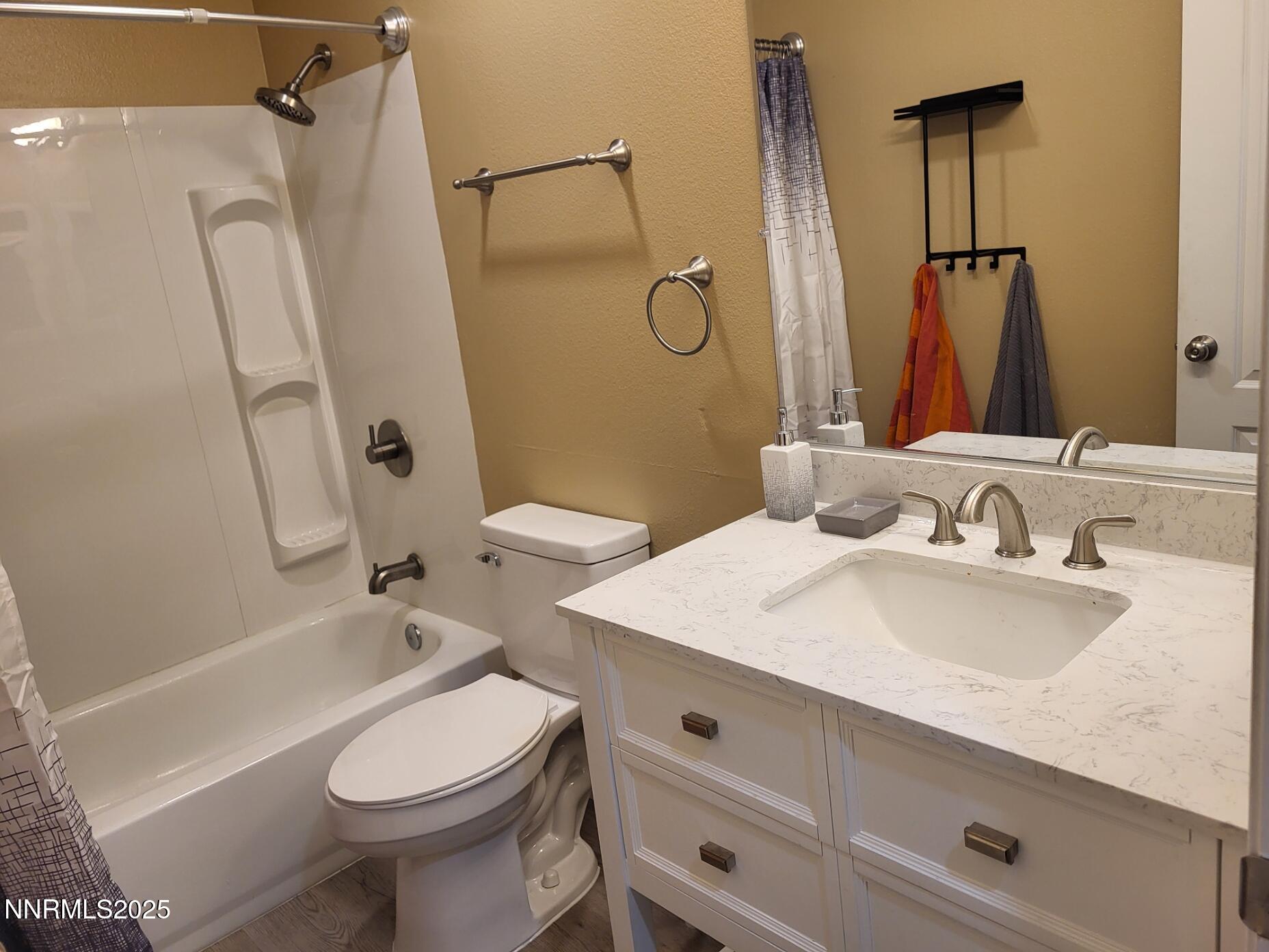 7871 Anchor Point Court Reno, NV 89506 - Photo 14 of 42 a bathroom with a sink toilet and shower