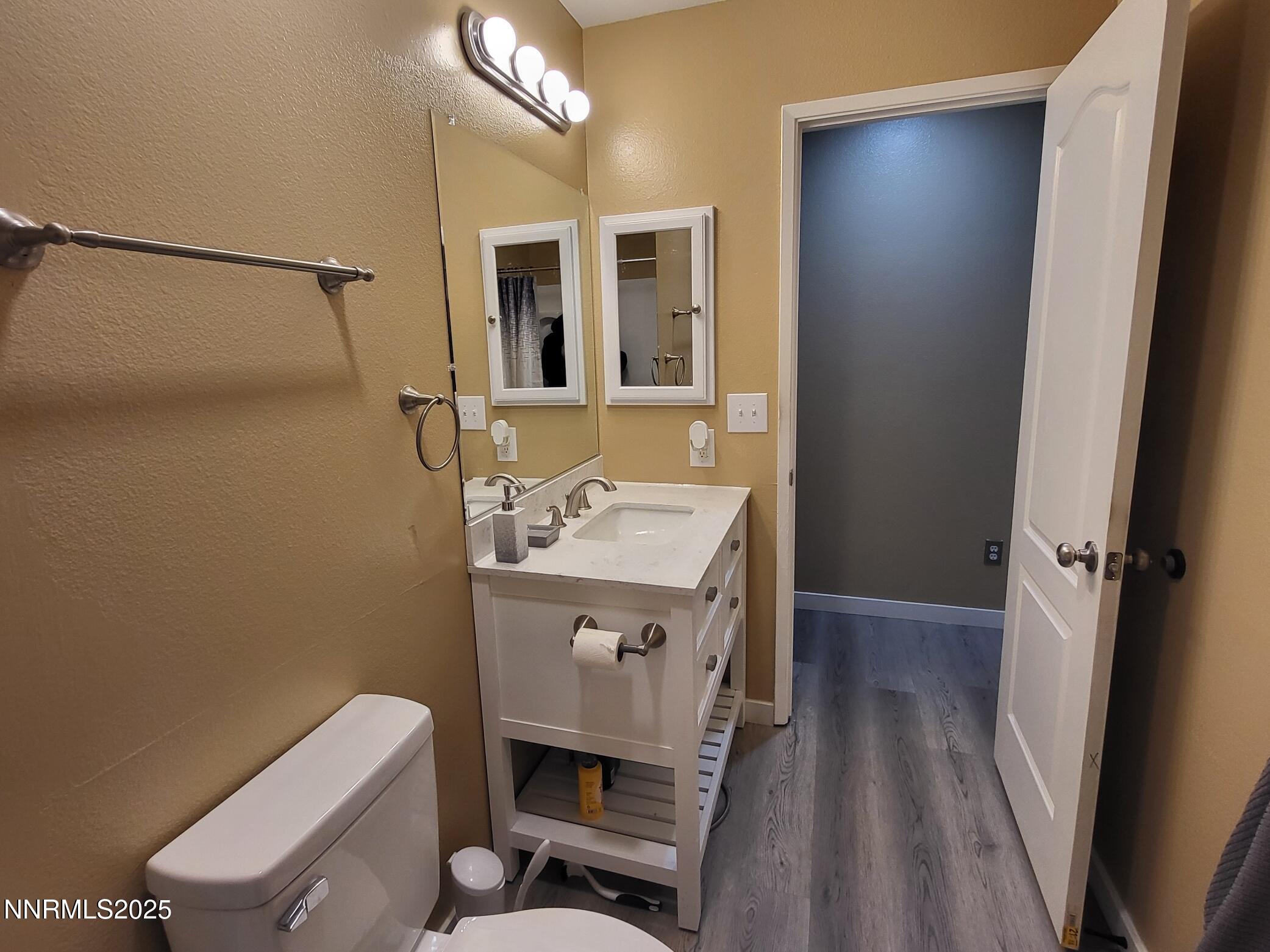 7871 Anchor Point Court Reno, NV 89506 - Photo 15 of 42 a bathroom with a sink a toilet a mirror and vanity