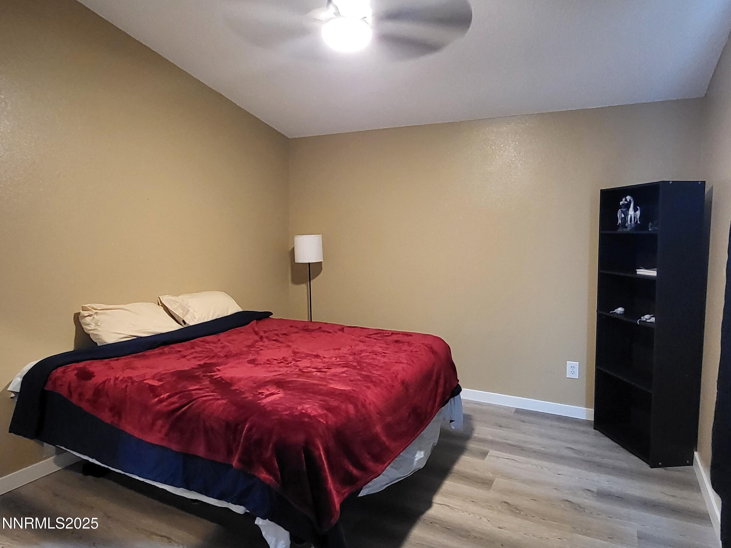 7871 Anchor Point Court Reno, NV 89506 - Photo 17 of 42 a bed sitting in a bedroom next to a bathroom