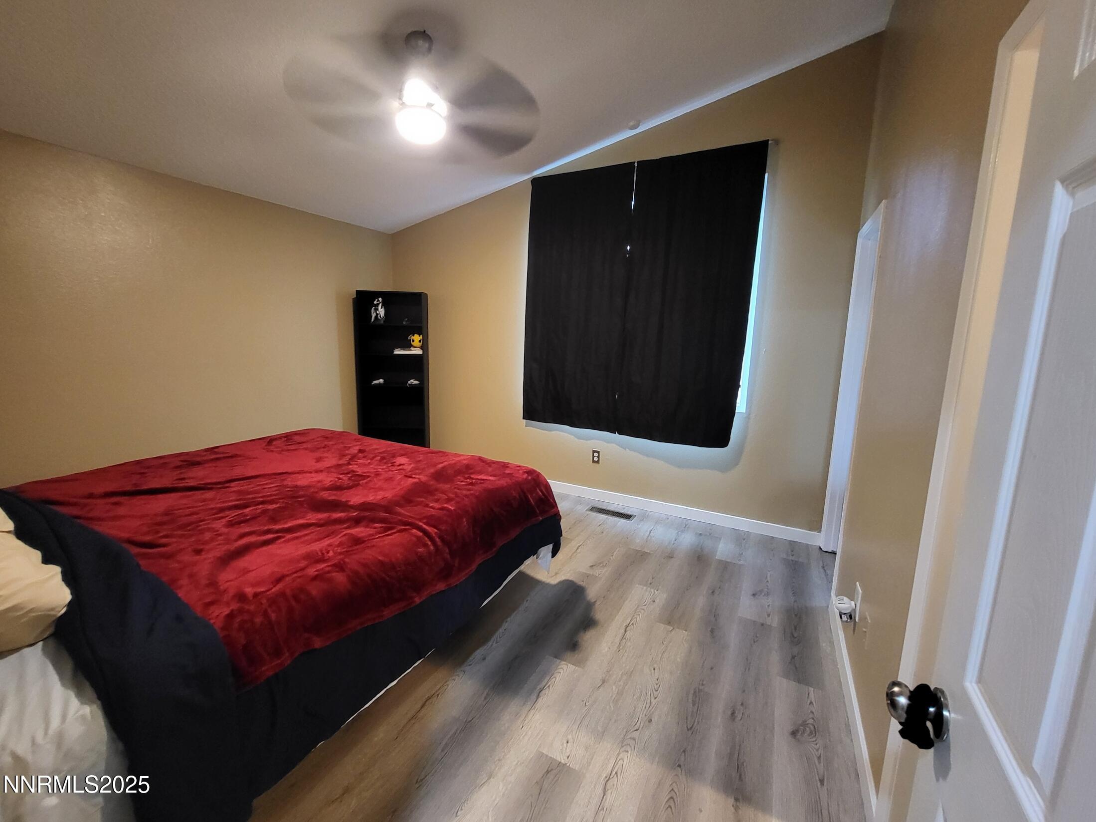 7871 Anchor Point Court Reno, NV 89506 - Photo 18 of 42 a spacious bedroom with a bed and a dresser