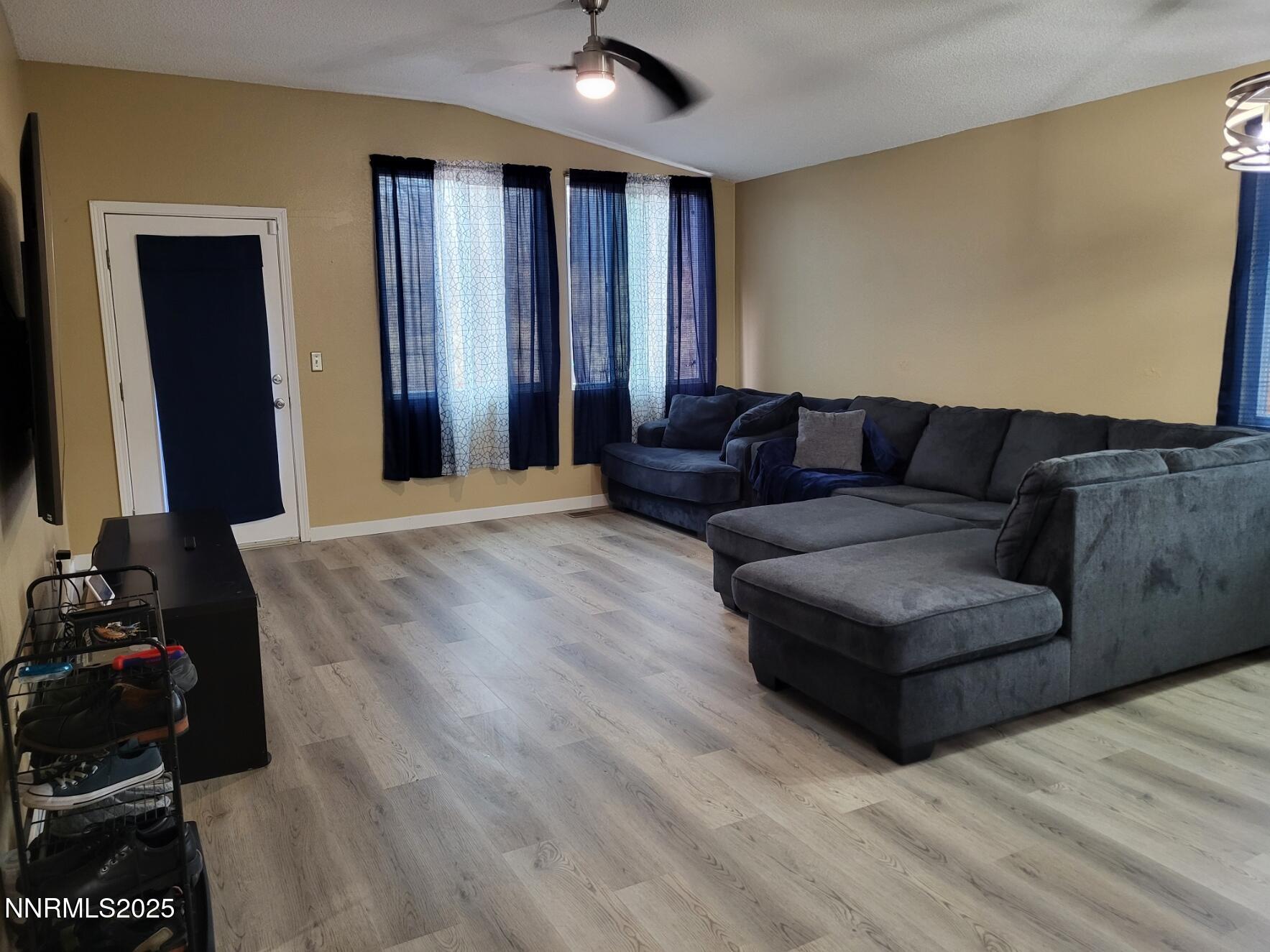 7871 Anchor Point Court Reno, NV 89506 - Photo 3 of 42 a living room with furniture and a flat screen tv