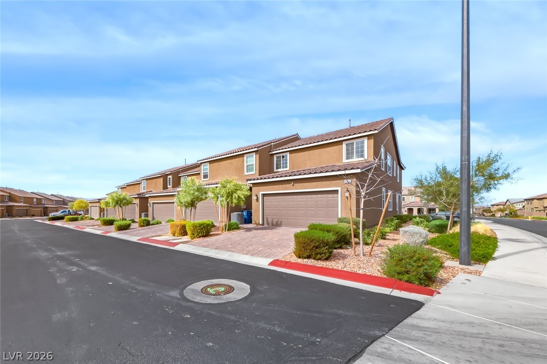 3564 Credere Lane Henderson, NV 89074 - Photo 36 of 40 View of front facade with a residential view, stucco siding, a tiled roof, and driveway
