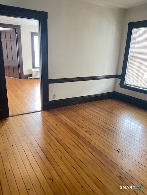 281 Chestnut Street New Britain, CT 06051 - Photo 14 of 33 wooden floor in an empty room with a window