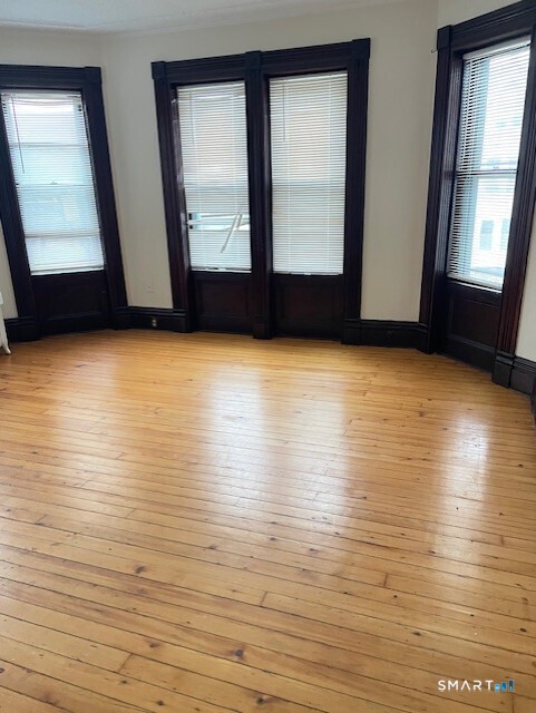 281 Chestnut Street New Britain, CT 06051 - Photo 15 of 33 an empty room with wooden floor and windows