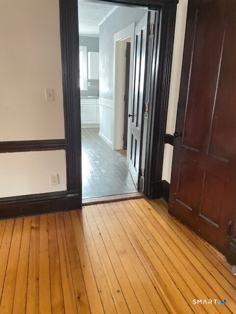 281 Chestnut Street New Britain, CT 06051 - Photo 18 of 33 a view of an empty room with wooden floor and a window