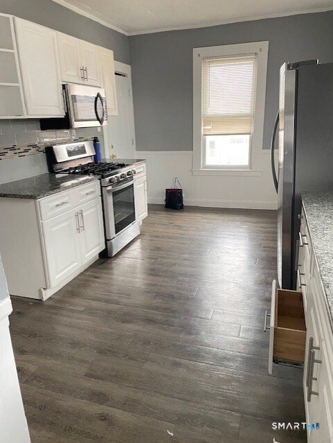 281 Chestnut Street New Britain, CT 06051 - Photo 2 of 33 a kitchen with stainless steel appliances a stove top oven and a refrigerator