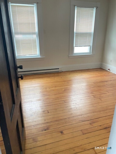 281 Chestnut Street New Britain, CT 06051 - Photo 22 of 33 an empty room with a wooden floor and a window