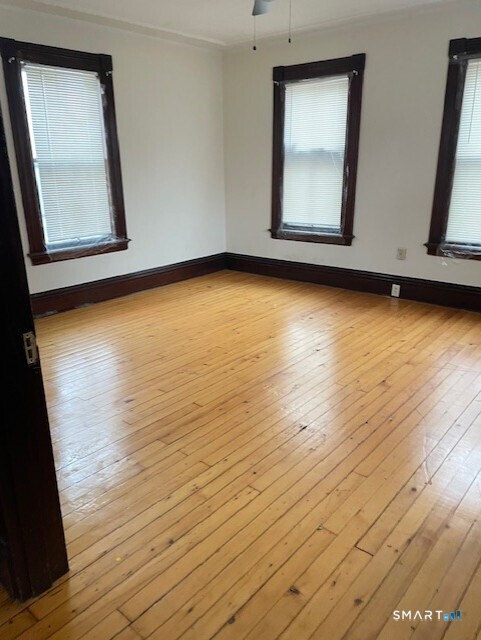 281 Chestnut Street New Britain, CT 06051 - Photo 23 of 33 a view of an empty room with wooden floor and a window