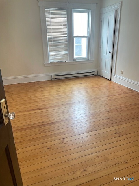 281 Chestnut Street New Britain, CT 06051 - Photo 28 of 33 a view of room with window and wooden floor