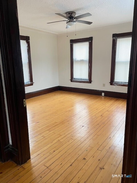 281 Chestnut Street New Britain, CT 06051 - Photo 29 of 33 wooden floor in an empty room with a window