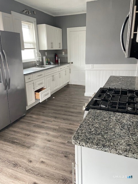 281 Chestnut Street New Britain, CT 06051 - Photo 3 of 33 a kitchen with stainless steel appliances granite countertop a sink stove and refrigerator
