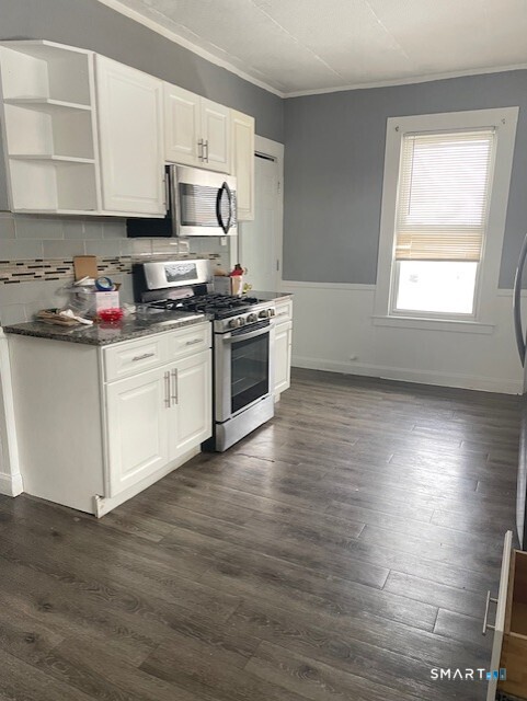 281 Chestnut Street New Britain, CT 06051 - Photo 5 of 33 a kitchen with granite countertop wooden floors and white stainless steel appliances