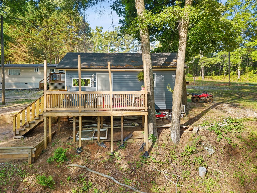 217 Old River Road Pelzer, SC 29669 - Photo 23 of 30 This elevated home offers a functional deck and a spacious surrounding yard, perfect for outdoor enjoyment.