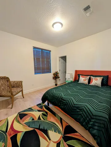 a bed room with a bed and a chair