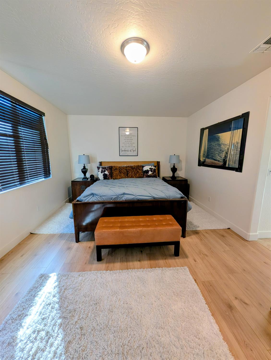 174 Emperor Way Dinuba, CA 93618 - Photo 17 of 23 a bedroom with a bed and a flat screen tv