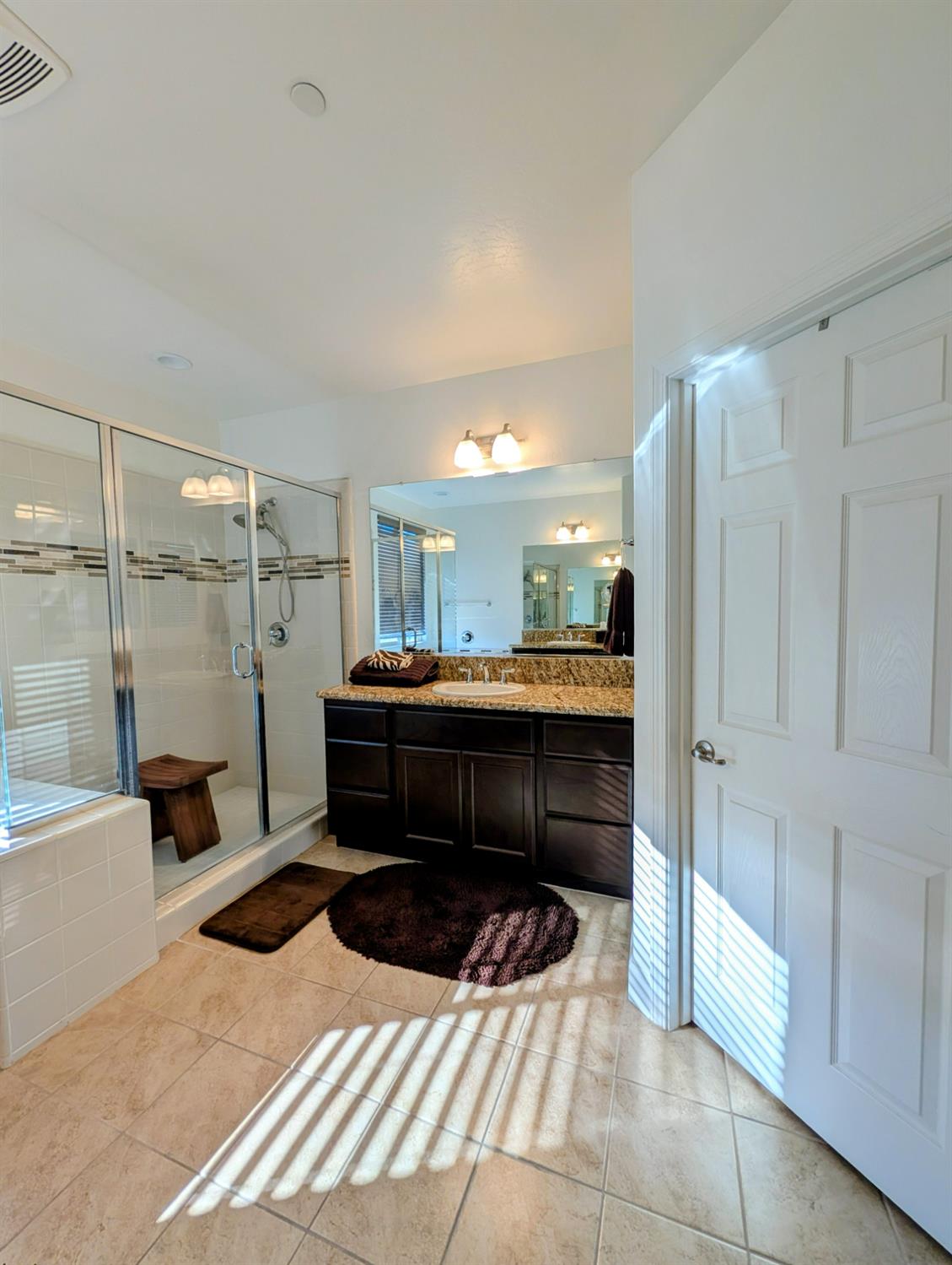 174 Emperor Way Dinuba, CA 93618 - Photo 18 of 23 a bathroom with a sink a toilet and shower