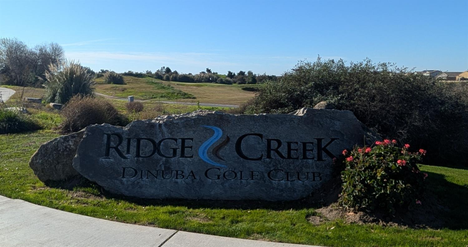 174 Emperor Way Dinuba, CA 93618 - Photo 22 of 23 a view of a sign board with lake view