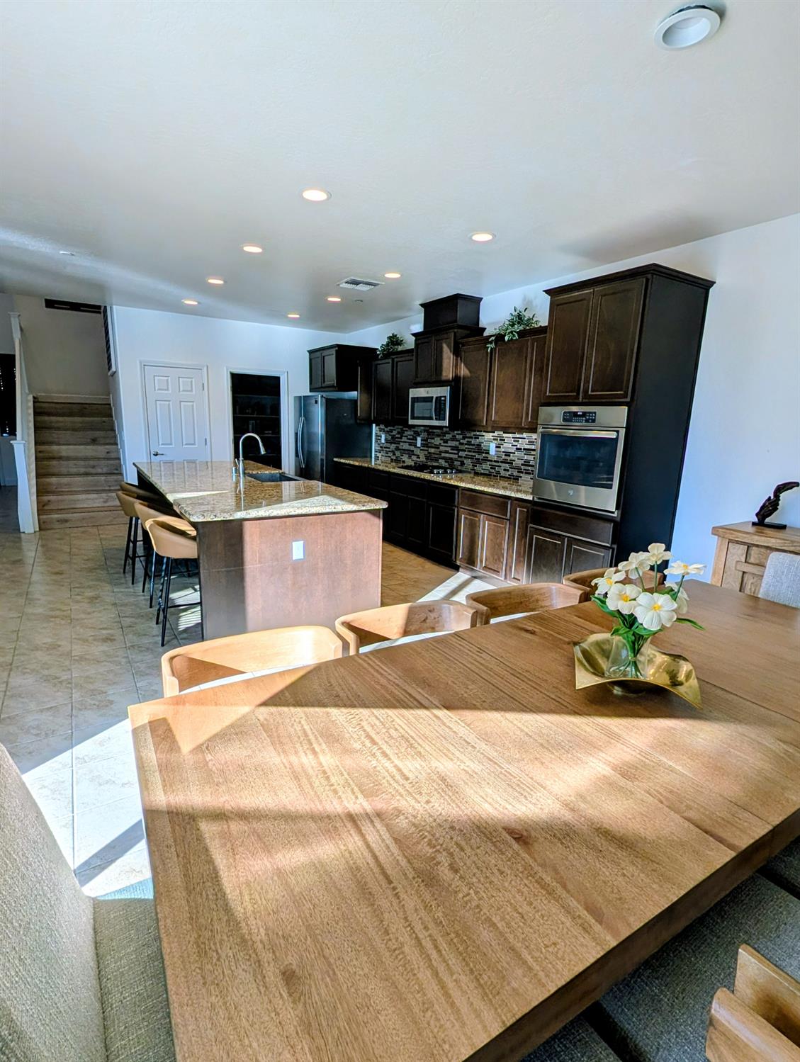 174 Emperor Way Dinuba, CA 93618 - Photo 6 of 23 a room with stainless steel appliances kitchen island granite countertop a sink and cabinets