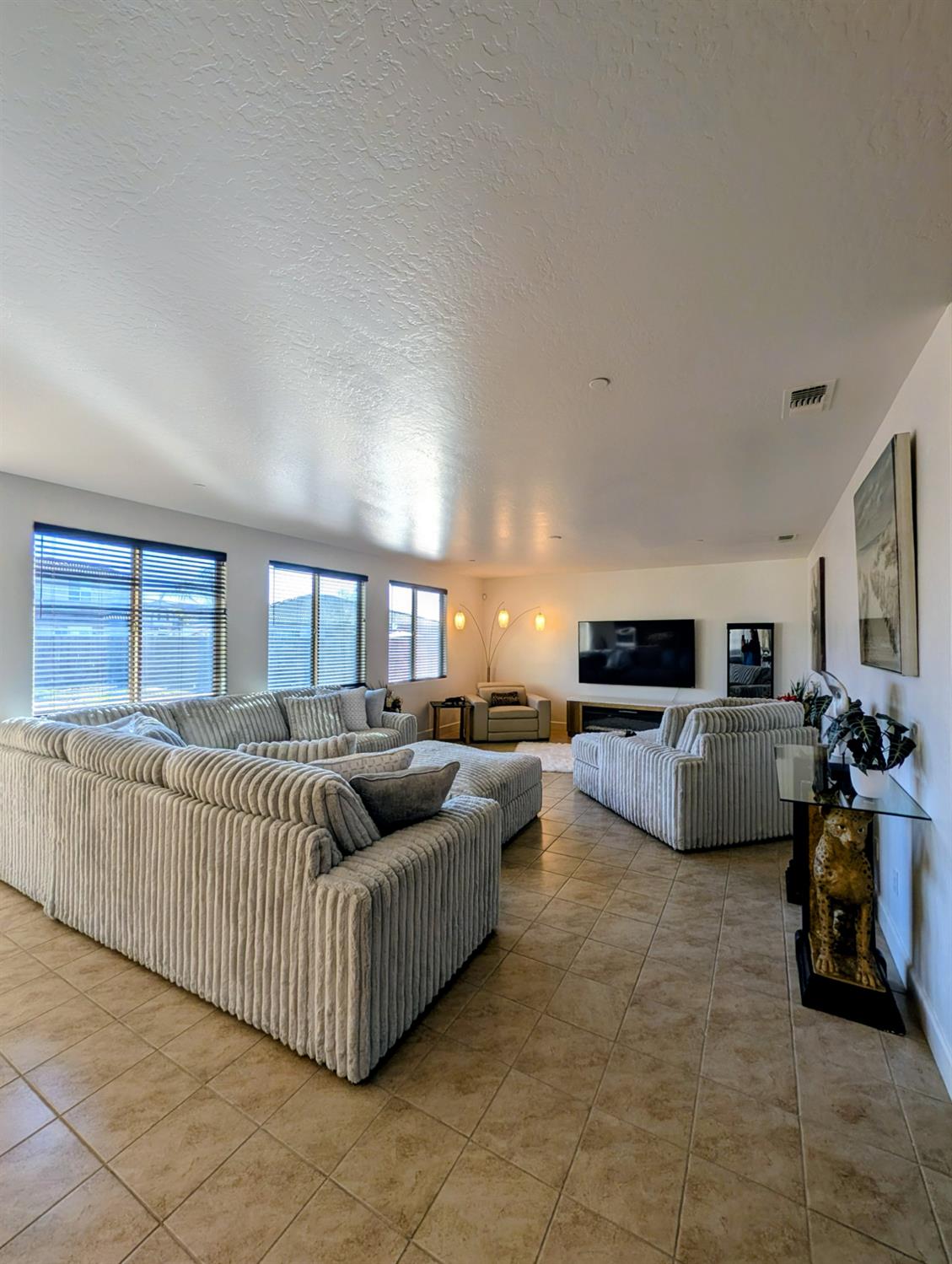 174 Emperor Way Dinuba, CA 93618 - Photo 7 of 23 a living room with furniture and a flat screen tv