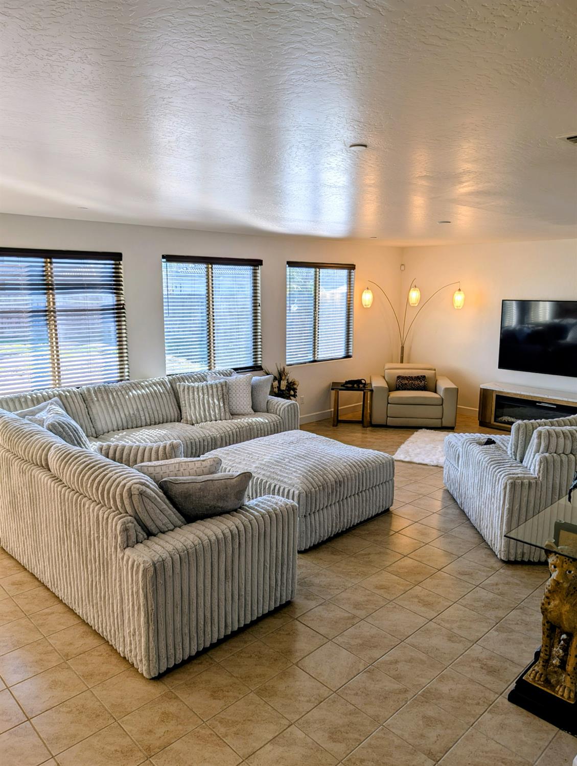 174 Emperor Way Dinuba, CA 93618 - Photo 8 of 23 a living room with furniture and a flat screen tv
