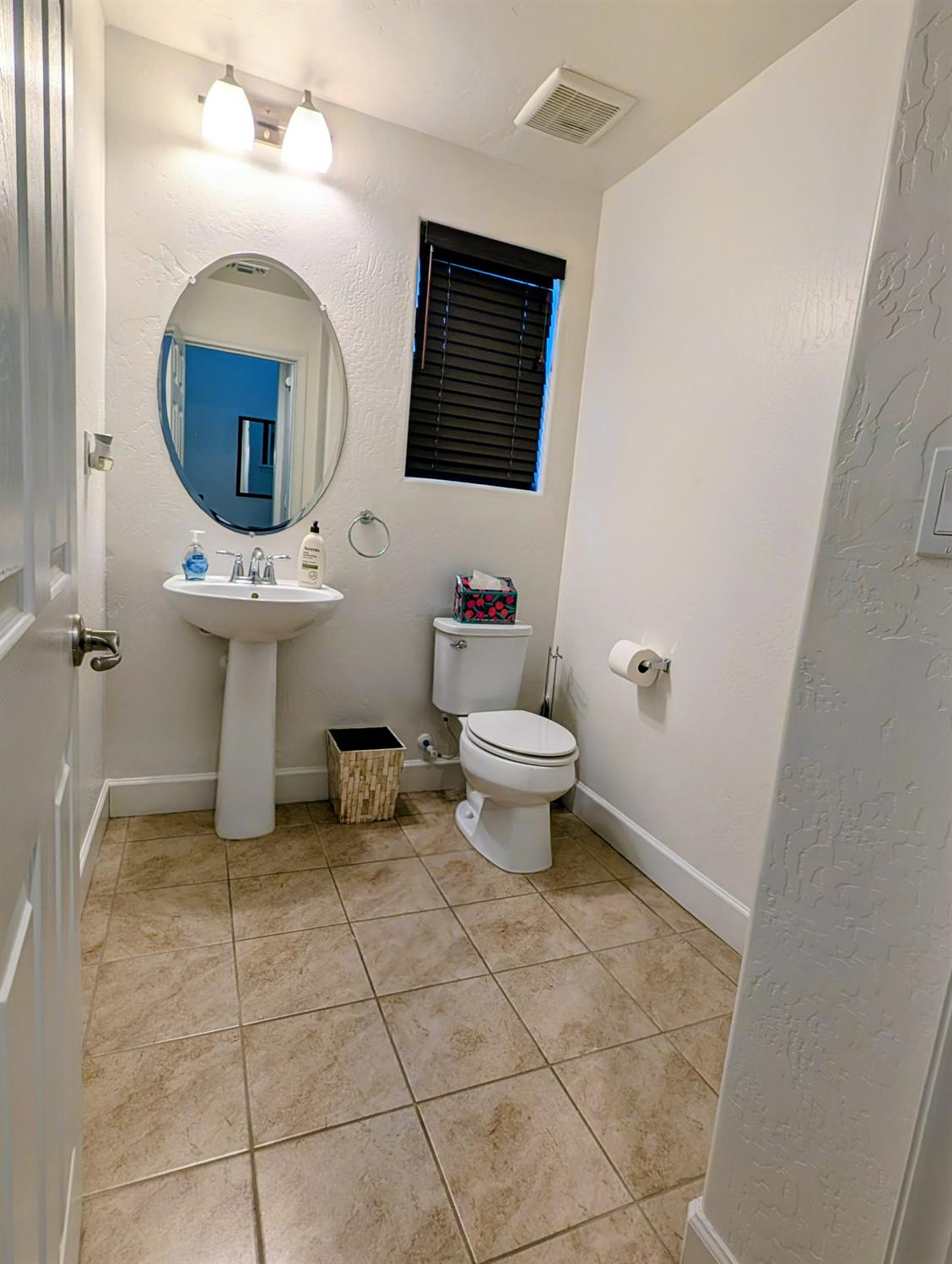 174 Emperor Way Dinuba, CA 93618 - Photo 10 of 23 a bathroom with a toilet sink and mirror