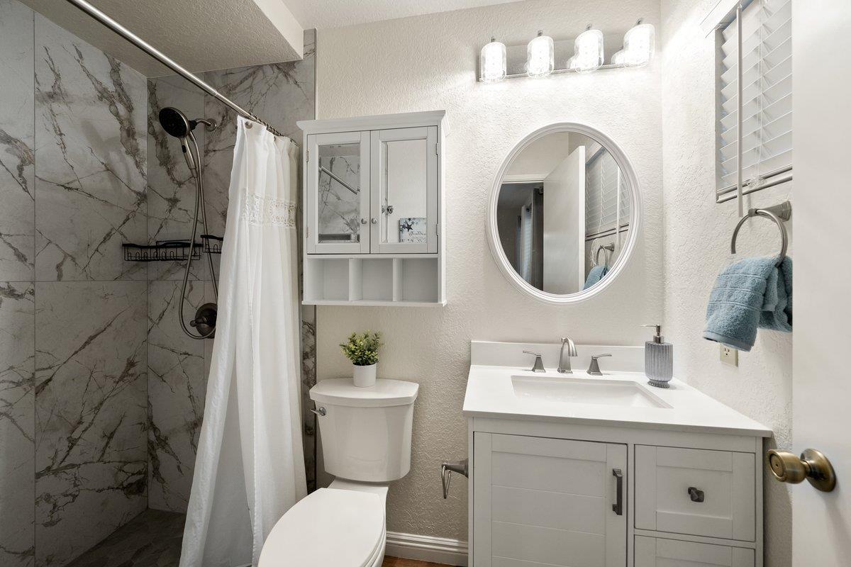 6561 Trinity Way Placerville, CA 95667 - Photo 16 of 58 a bathroom with a sink mirror vanity and toilet