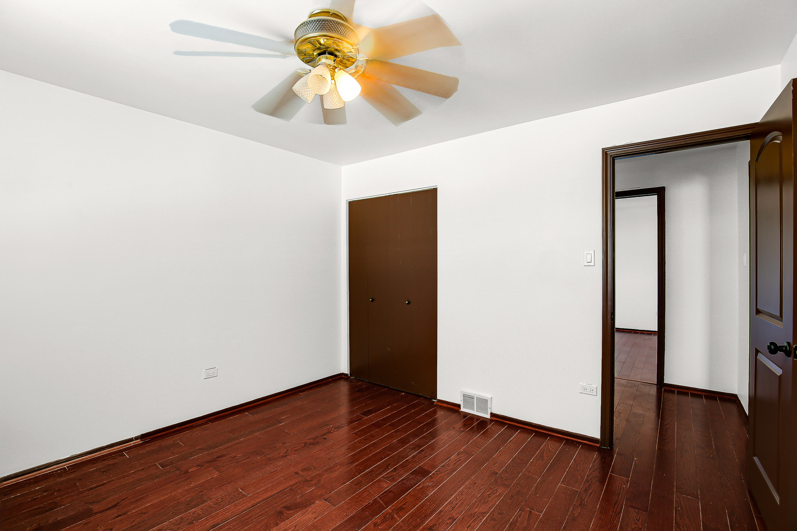 8424 Currant Avenue Tinley Park, IL 60487 - Photo 12 of 23 a view of an empty room with wooden floor