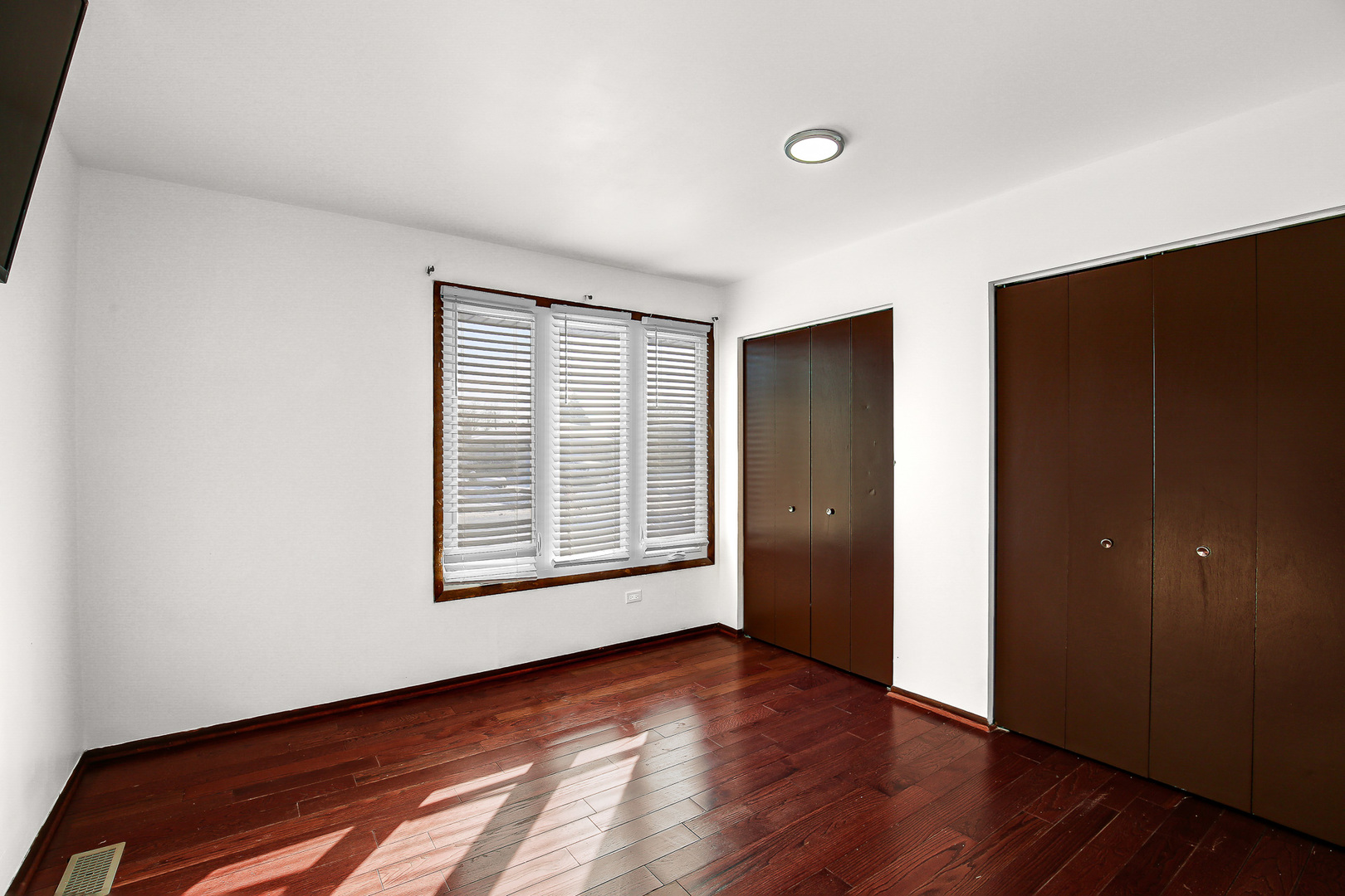 8424 Currant Avenue Tinley Park, IL 60487 - Photo 19 of 23 an empty room with wooden floor and windows